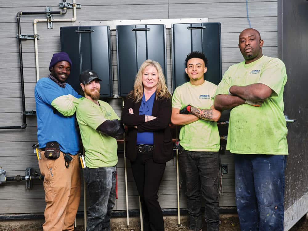 Tonya Reed of Henry Plumbing poses with other team members.