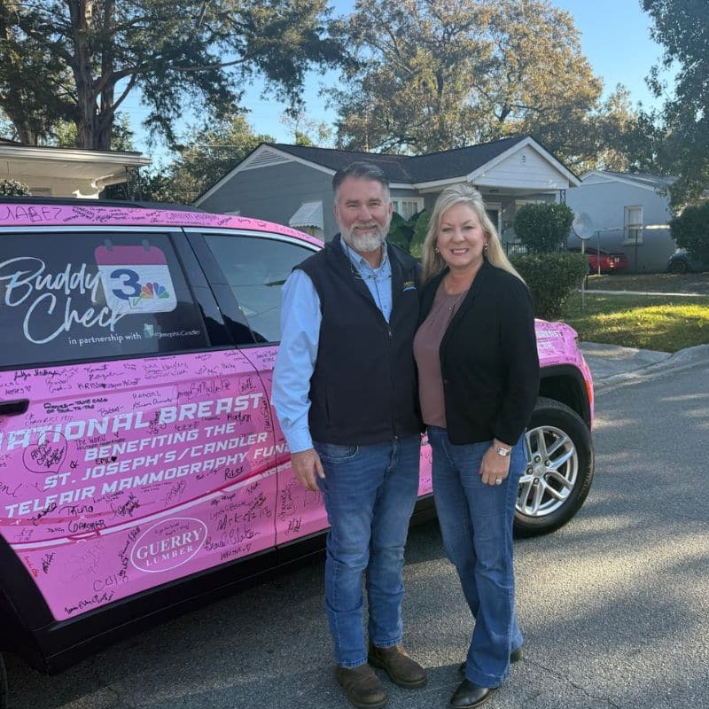 Todd Reed and Tonya Reed post in front of WSAV-TV's Buddy Check pink SUV in honor of National Breast Cancer Month.