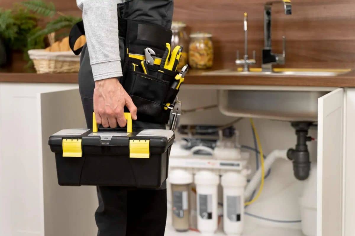 Professional plumber carrying toolbox for residential plumbing repair
