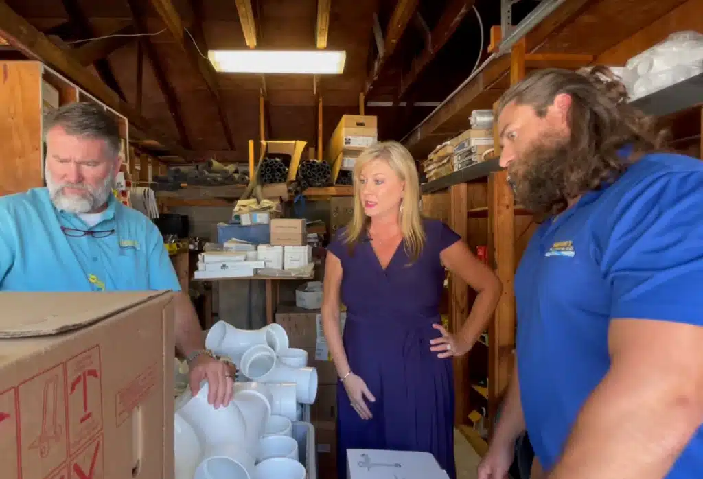 Tonya Reed, Todd Reed and their son walk through Henry Plumbing warehouse and supply area