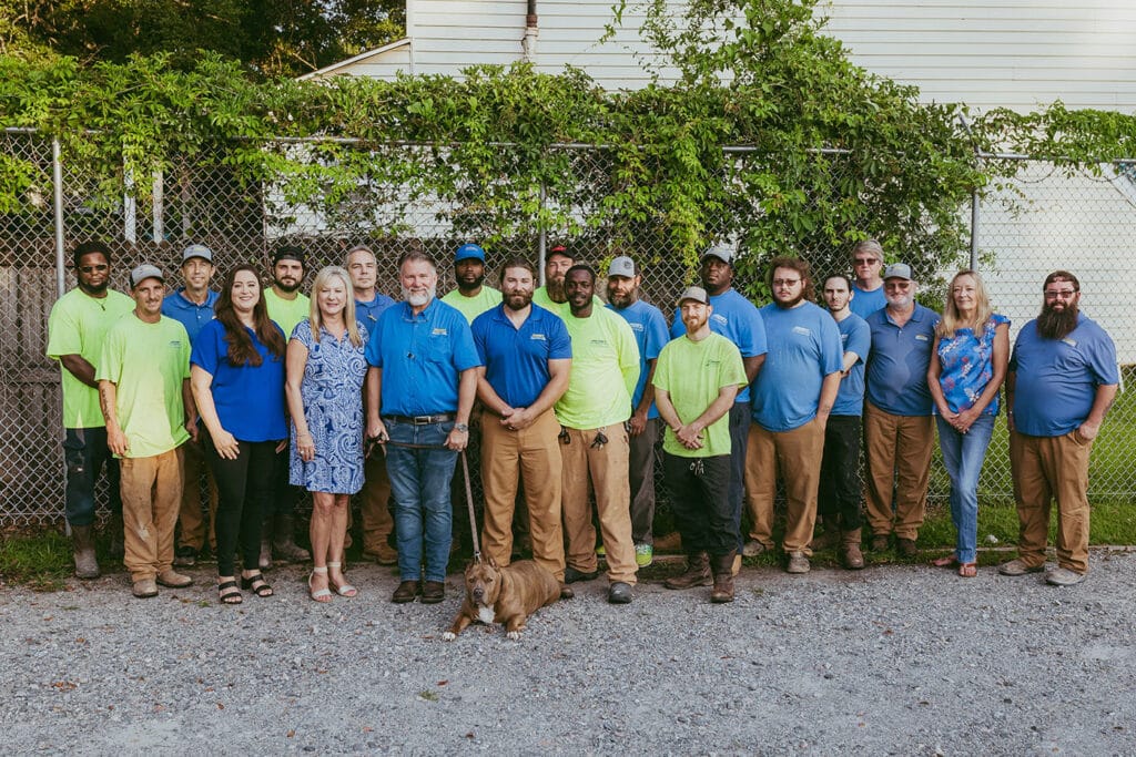 Henry Plumbing team photo with staff members outdoors