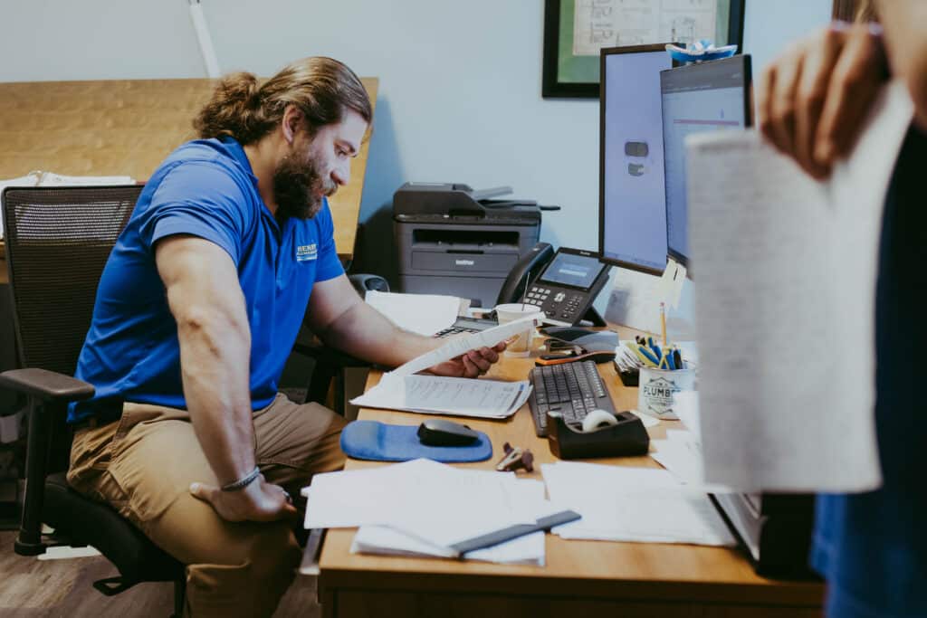Henry Plumbing's Tanner Reed assisting customer with scheduling and service coordination