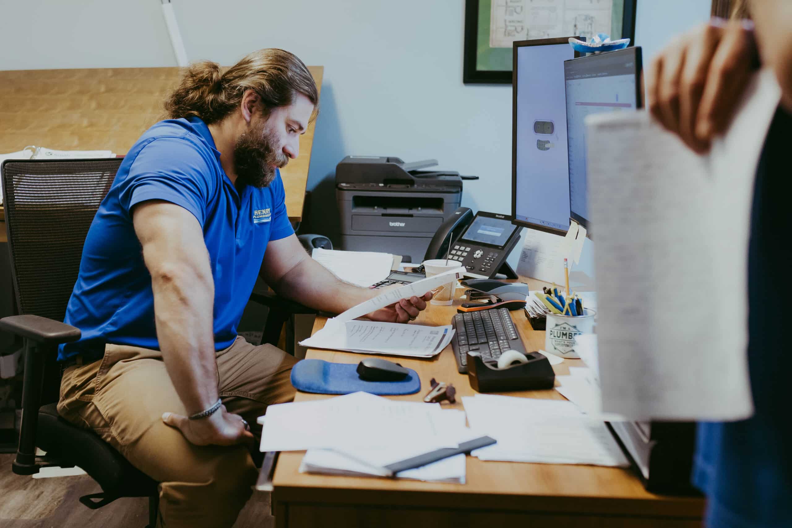 Henry Plumbing's Tanner Reed assisting customer with scheduling and service coordination