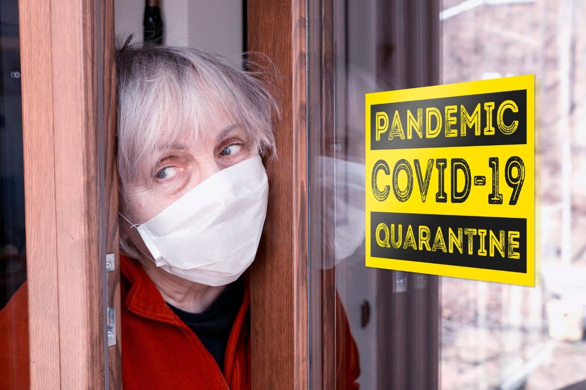 Woman wearing mask during COVID-19 quarantine at home