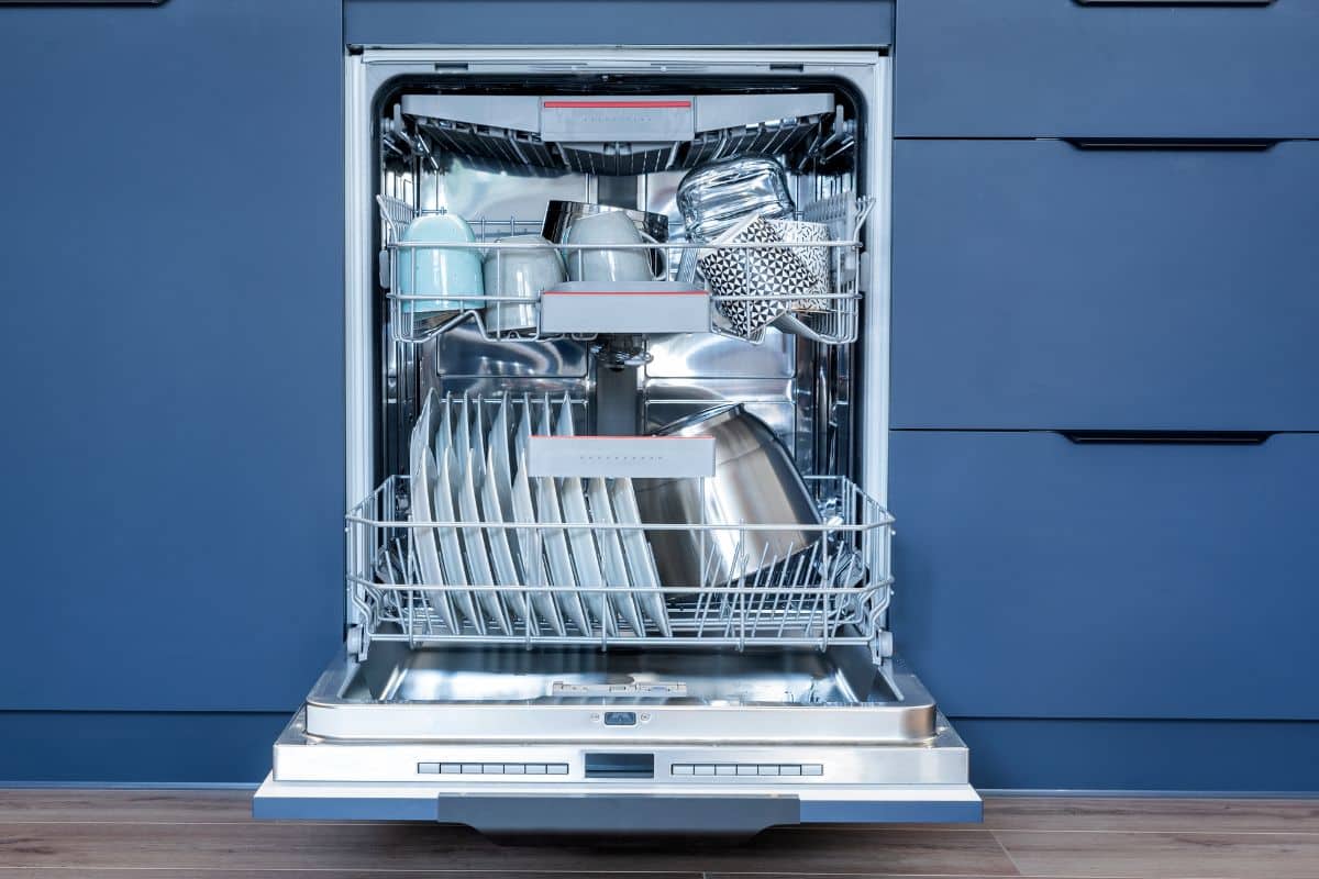A dishwasher full of cups, plates, bowls