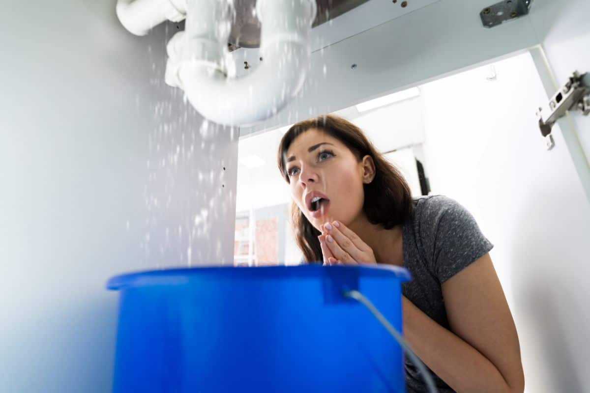 Homeowner dealing with plumbing overflow and emergency water damage
