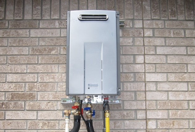 Outdoor tankless water heater installation on residential home