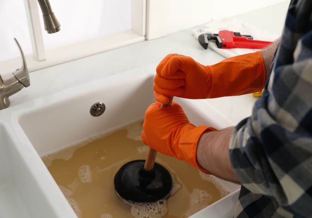 Toilet plunger clearing bathroom drain clog in Savannah GA